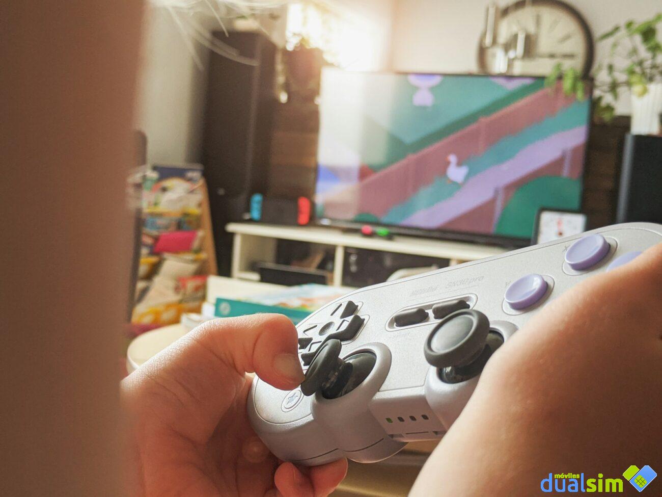 person holding white and black xbox one game controller