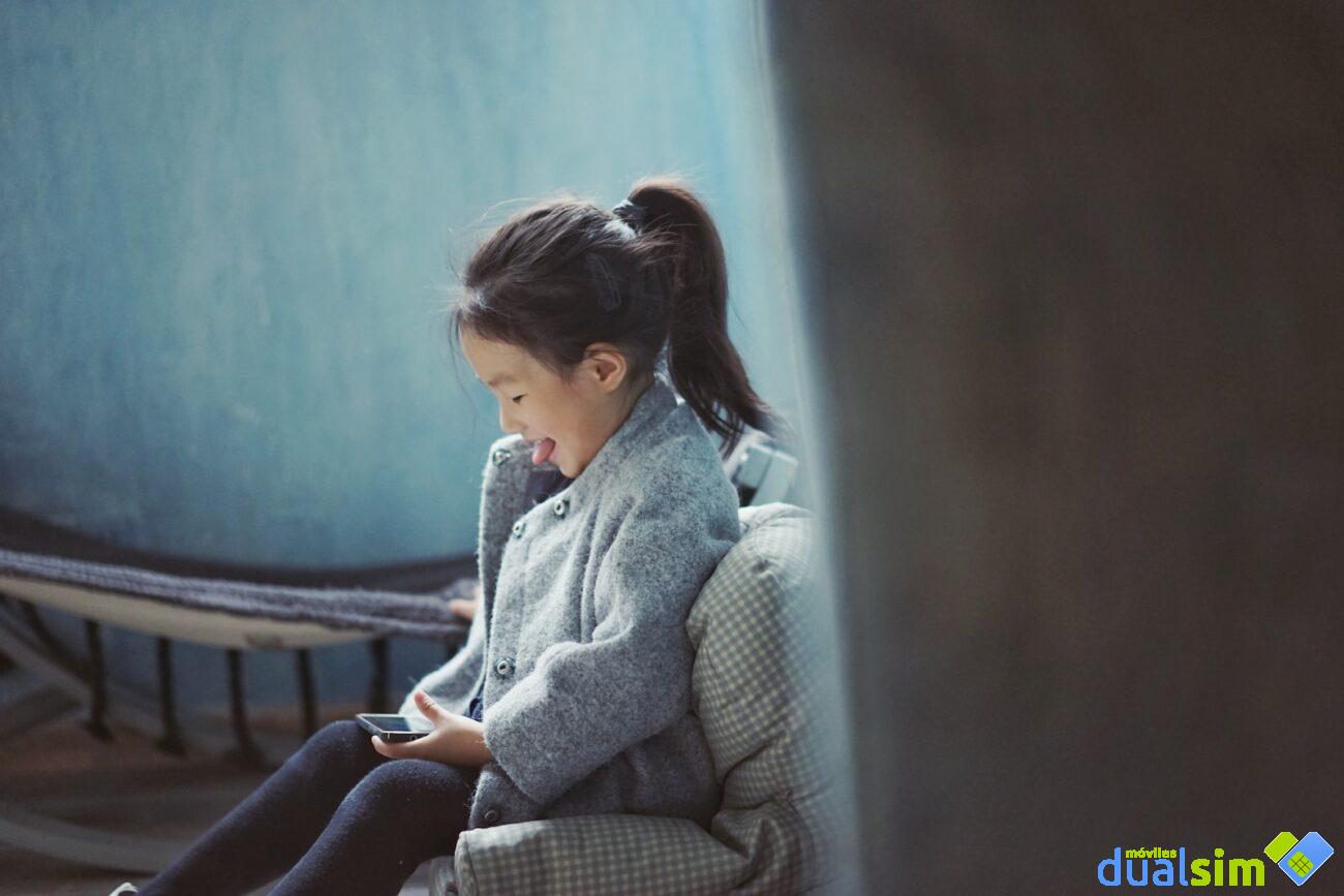 girl sticking her tongue out while using mobile phone